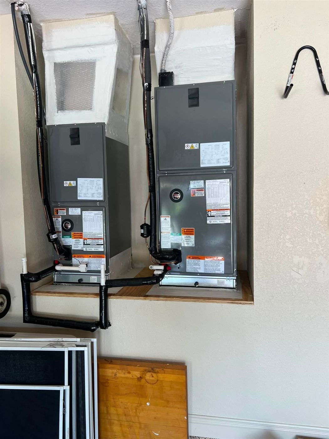 Two new air handlers installed in a utility closet