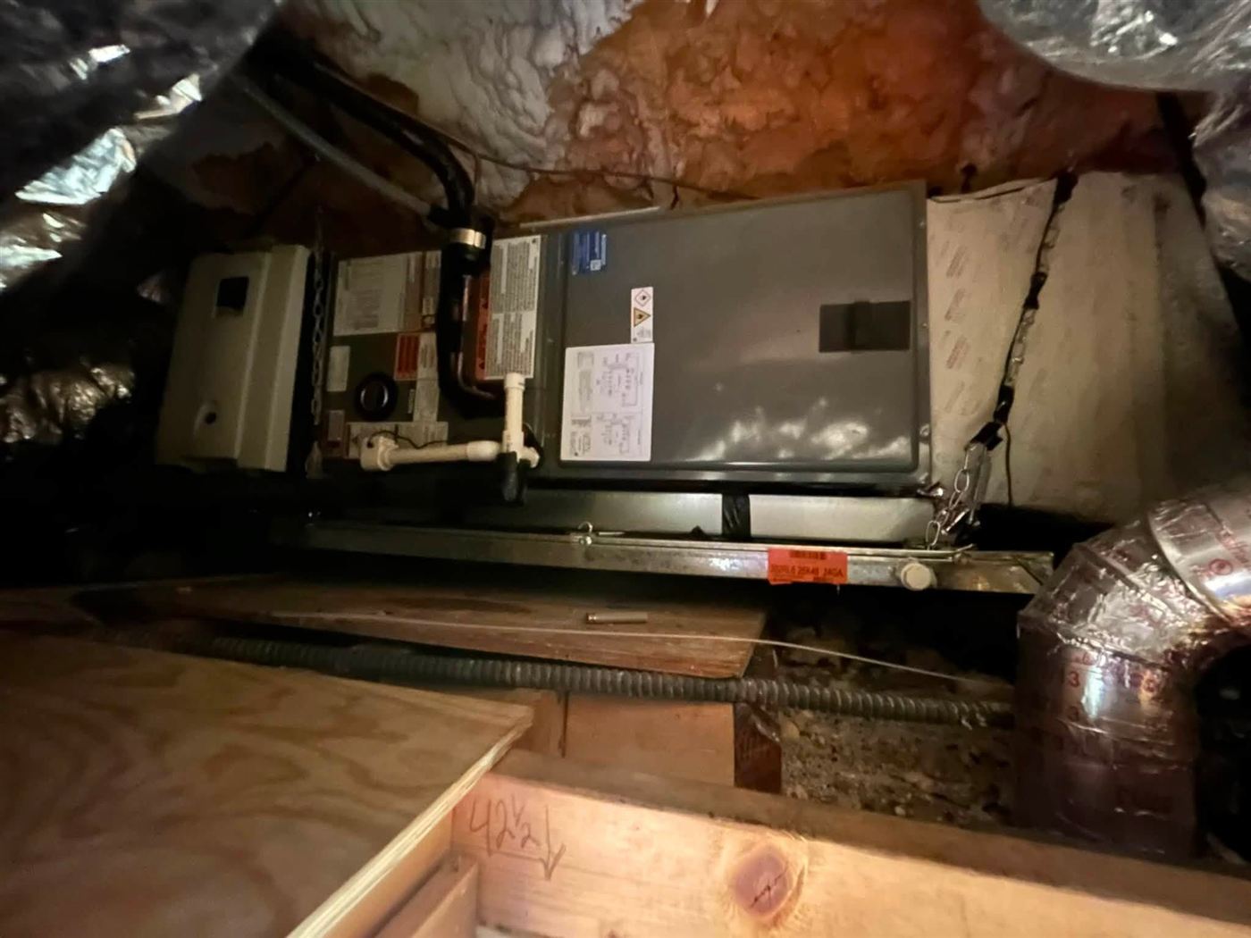 Air handler installed on a platform in an attic