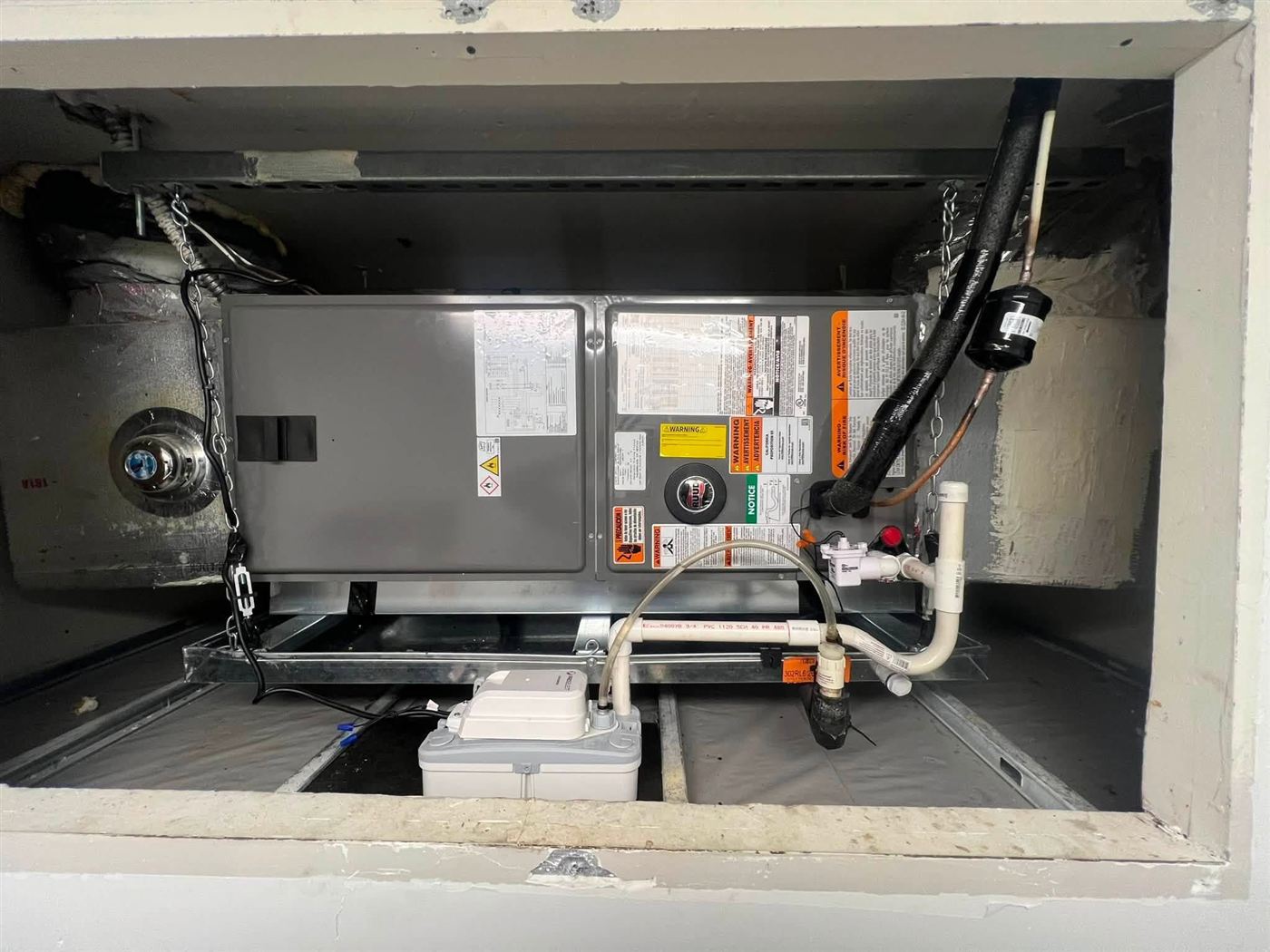 Air handler installed in a ceiling closet with new drain line