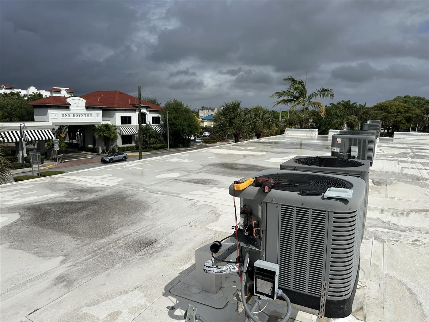New AC condenser installed on a flat commercial rooftop